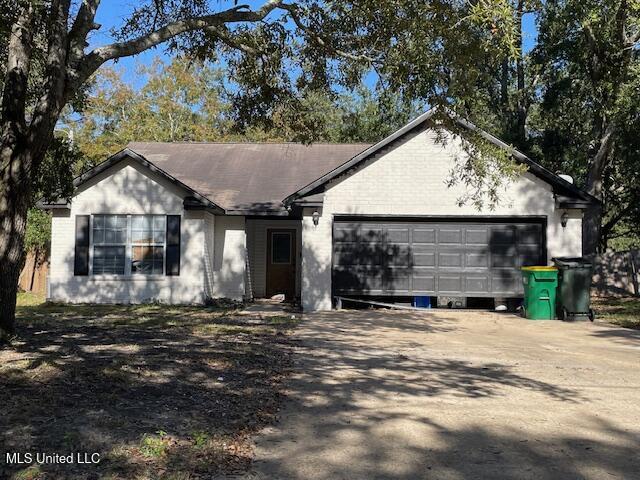 ranch-style home featuring a garage