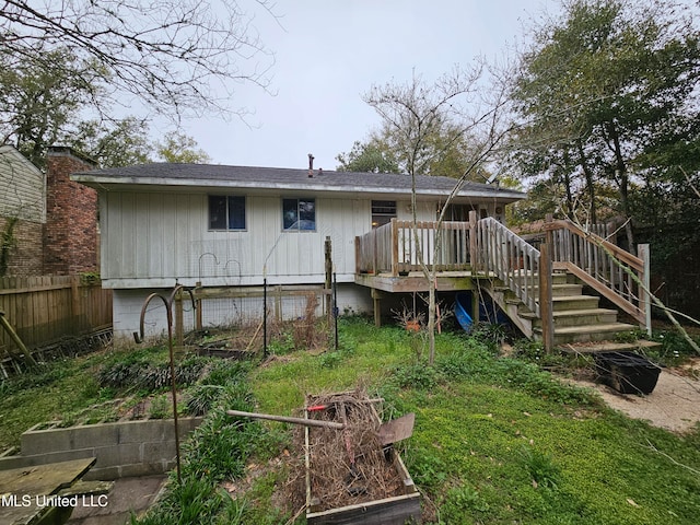 rear view of property featuring a wooden deck