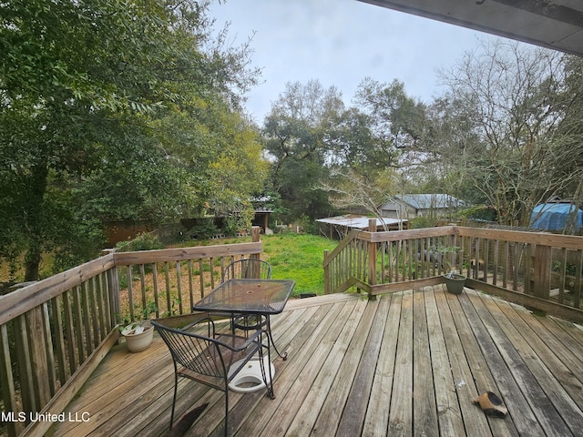 wooden terrace with a lawn