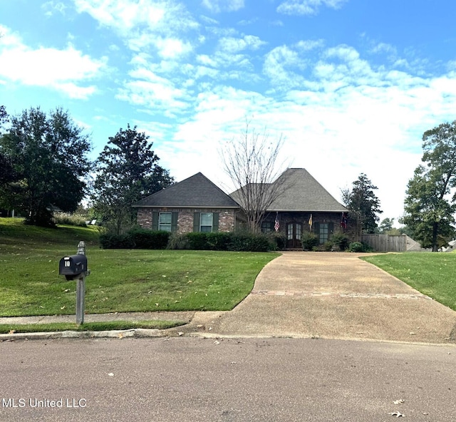 ranch-style home featuring a front lawn