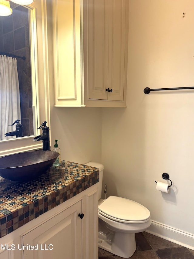 bathroom with toilet and vanity
