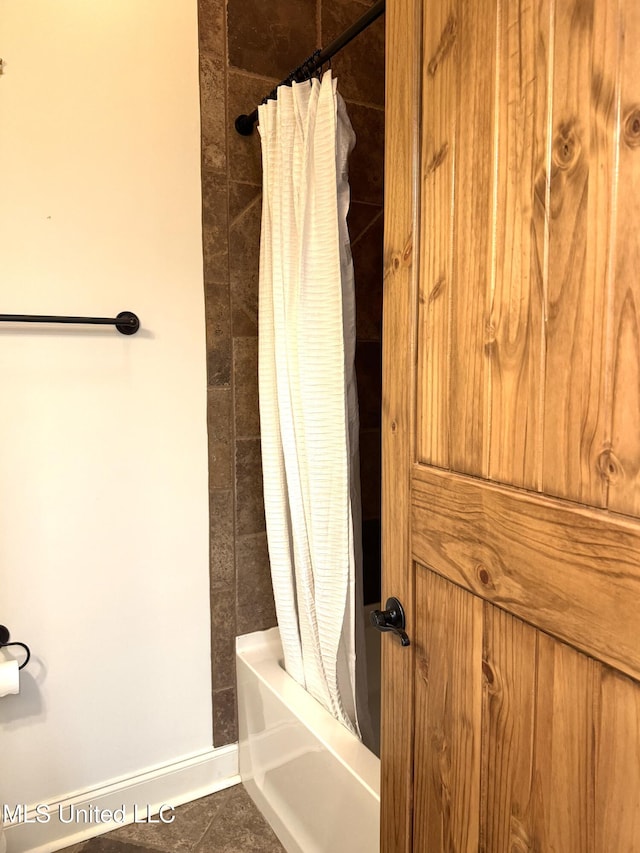 bathroom featuring shower / bath combination with curtain and tile patterned floors