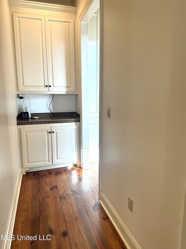 corridor with dark wood-type flooring