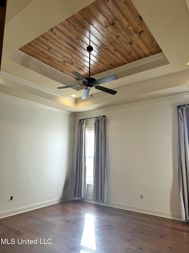 unfurnished room featuring a tray ceiling, wood ceiling, dark hardwood / wood-style floors, and crown molding