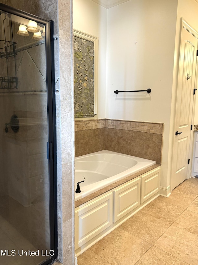 bathroom with a bathing tub and tile patterned floors
