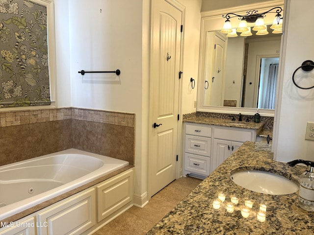 bathroom with a bathtub, vanity, and tile patterned flooring