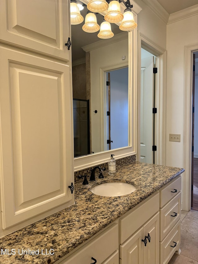 bathroom featuring walk in shower, vanity, tile patterned floors, and crown molding