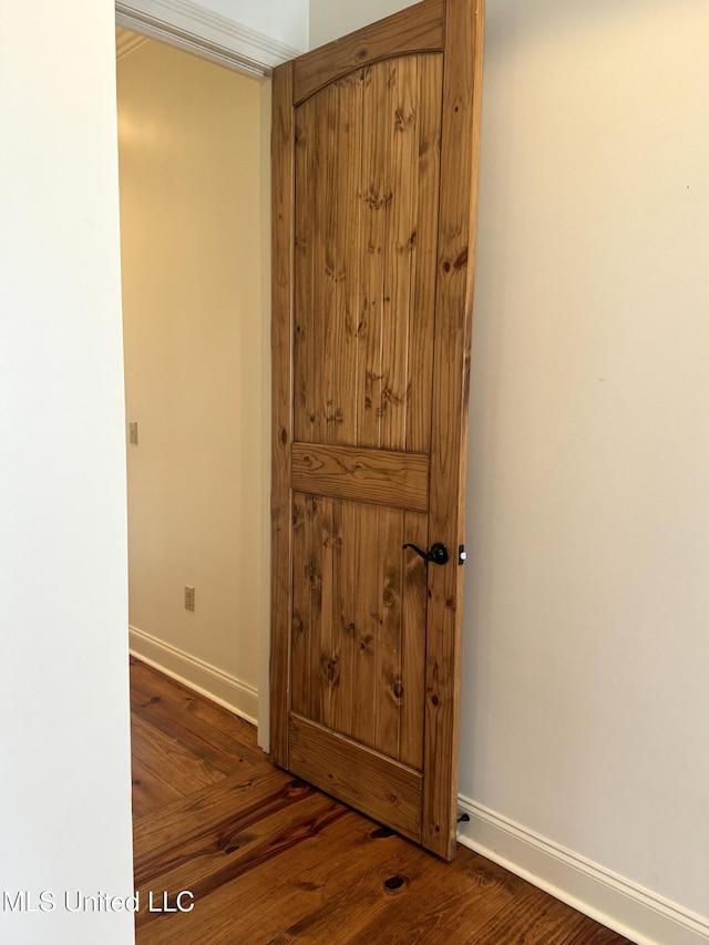 hallway with dark hardwood / wood-style flooring