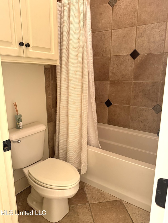 bathroom with tile patterned floors, toilet, and shower / tub combo