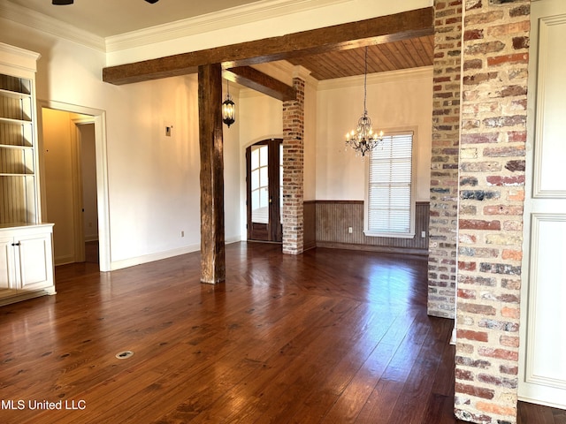 unfurnished living room with beamed ceiling, a chandelier, crown molding, ornate columns, and dark hardwood / wood-style flooring