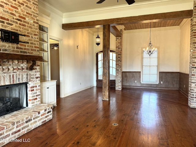 unfurnished living room featuring a wealth of natural light, beamed ceiling, and dark hardwood / wood-style floors