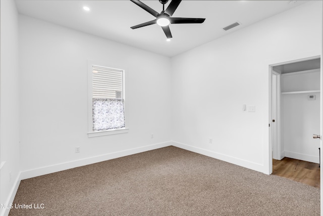 unfurnished bedroom with carpet flooring, recessed lighting, baseboards, a spacious closet, and a ceiling fan