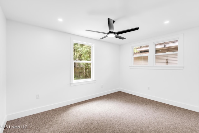 carpeted empty room featuring plenty of natural light, ceiling fan, recessed lighting, and baseboards