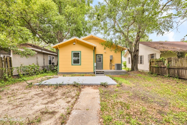 rear view of house with fence, a patio, and central air condition unit