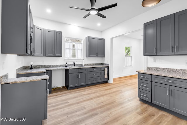 kitchen featuring a sink, a ceiling fan, light wood-style floors, gray cabinets, and recessed lighting