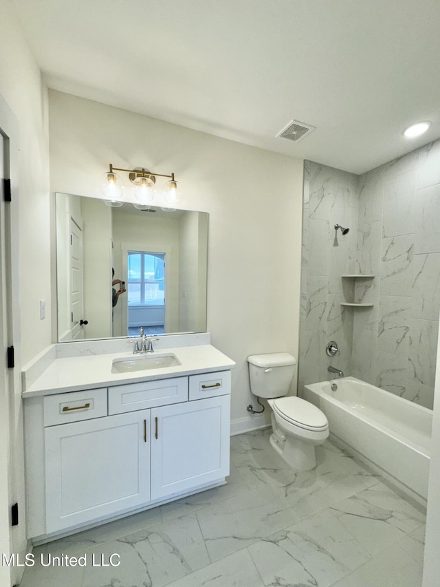 full bathroom with vanity, tiled shower / bath combo, and toilet