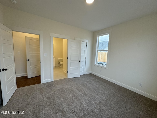 unfurnished bedroom featuring dark colored carpet