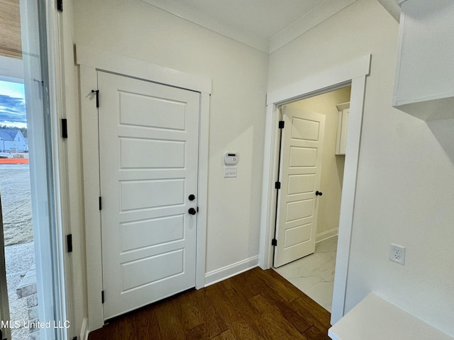 entryway featuring ornamental molding and hardwood / wood-style flooring