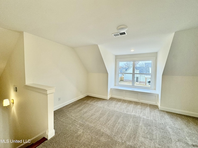 bonus room with carpet floors and lofted ceiling