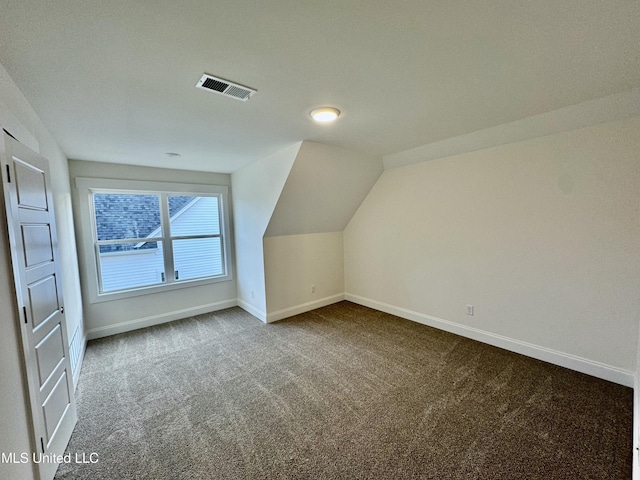 bonus room featuring carpet and vaulted ceiling