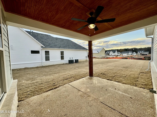 patio terrace at dusk featuring ceiling fan and cooling unit