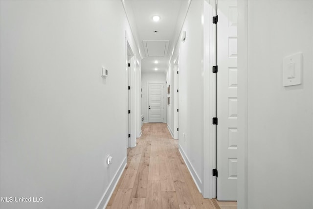 hallway featuring light wood-type flooring and crown molding