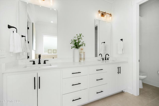 bathroom featuring tile patterned floors, vanity, and toilet