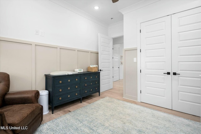 sitting room featuring crown molding and light hardwood / wood-style flooring