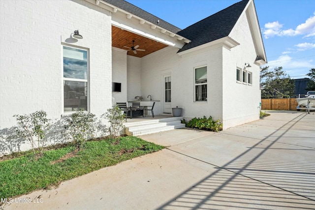 rear view of house featuring a patio area and ceiling fan