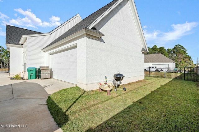 view of side of home featuring a yard and a garage