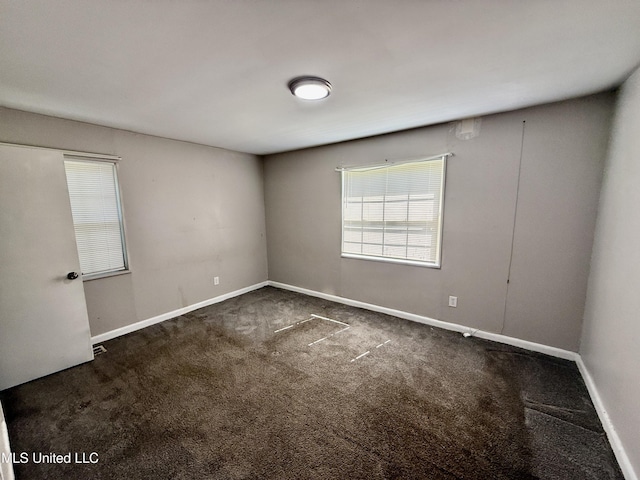 carpeted empty room with baseboards