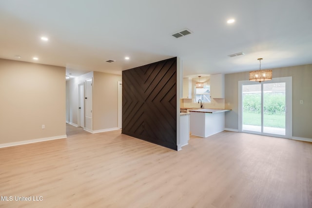 392 Lawler Ave, Long Beach, MS 39560 - unfurnished living room featuring light wood-style flooring, recessed lighting, and baseboards