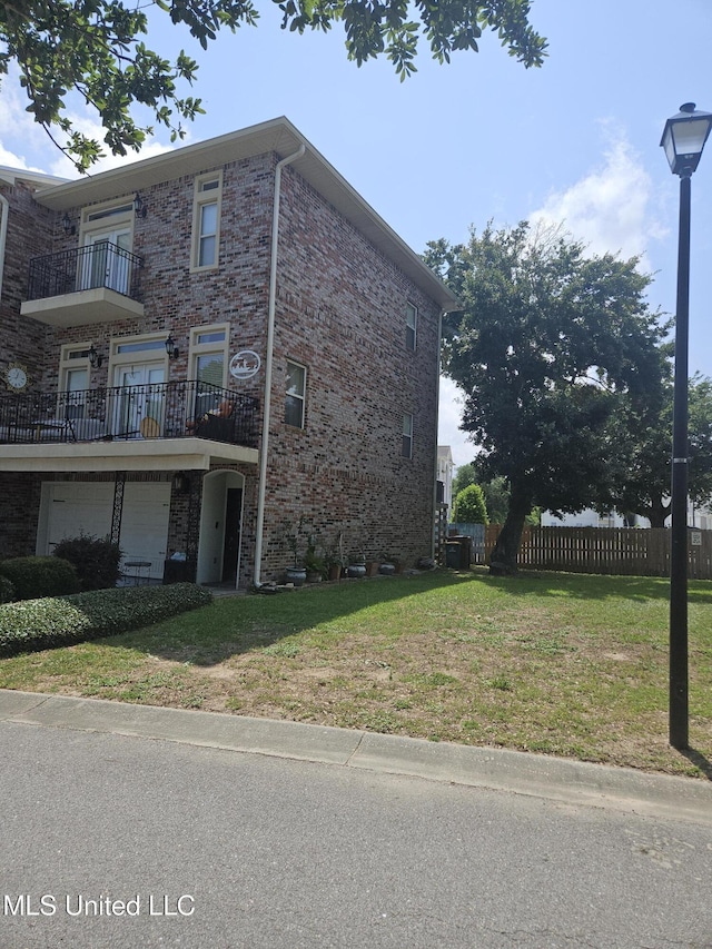 21 Oak Alley Ln, Long Beach, MS 39560 - view of home's exterior featuring a balcony and brick siding