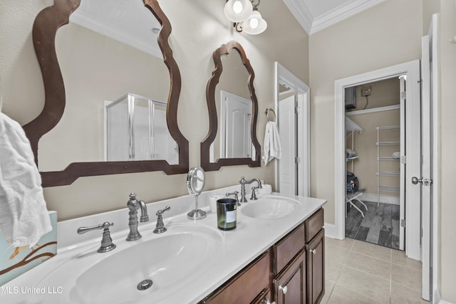 21 Oak Alley Ln, Long Beach, MS 39560 - full bath featuring crown molding, tile patterned floors, double vanity, a shower stall, and a walk in closet