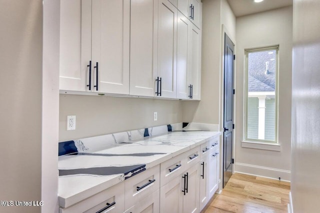 laundry room with a wealth of natural light and light wood-type flooring