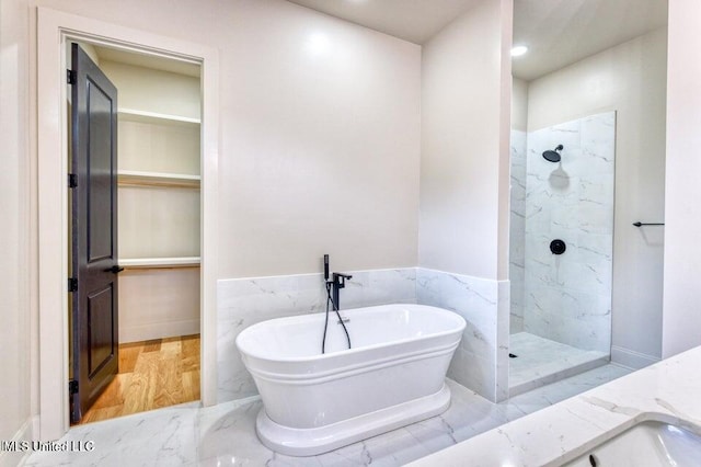 bathroom featuring vanity and separate shower and tub