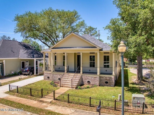 bungalow with a front yard and covered porch