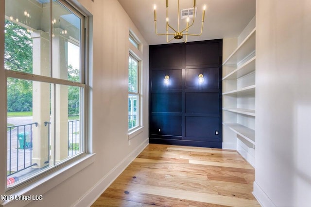 entrance foyer featuring a chandelier and light wood-type flooring