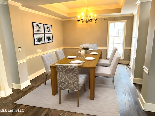 dining area with a notable chandelier, a raised ceiling, and crown molding