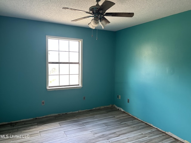 5909 Waltman Rd, Vancleave, MS 39565 - empty room with ceiling fan, light hardwood / wood-style flooring, and a textured ceiling