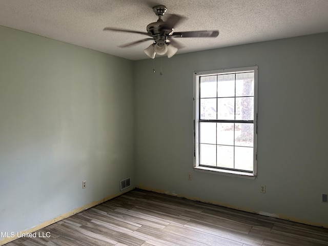 5909 Waltman Rd, Vancleave, MS 39565 - unfurnished room with ceiling fan, a textured ceiling, and light hardwood / wood-style flooring