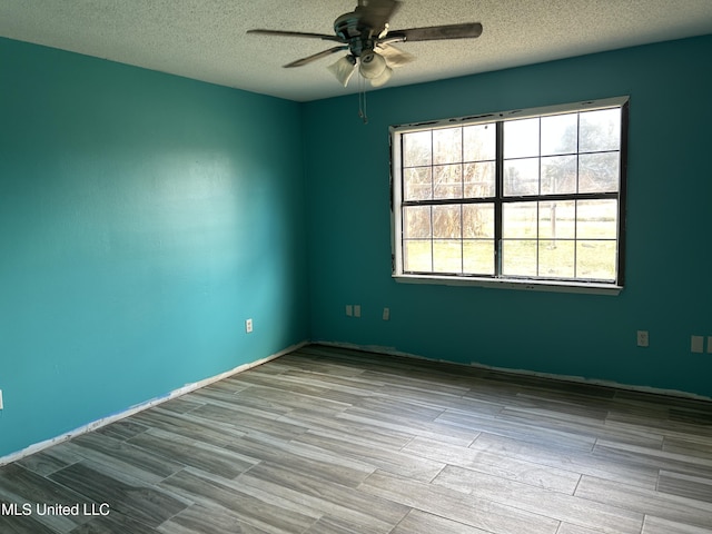 5909 Waltman Rd, Vancleave, MS 39565 - unfurnished room with ceiling fan, light hardwood / wood-style floors, and a textured ceiling
