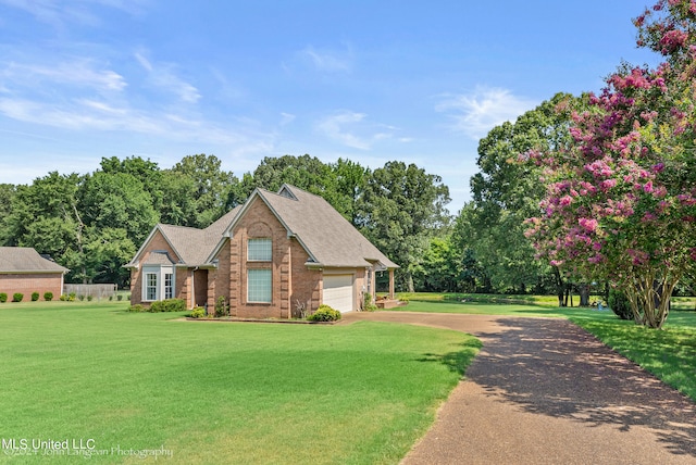 view of front of property featuring a front yard and a garage