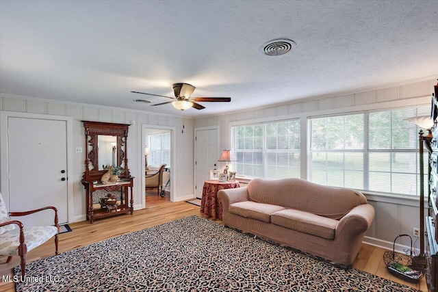 living room featuring light wood-type flooring and ceiling fan