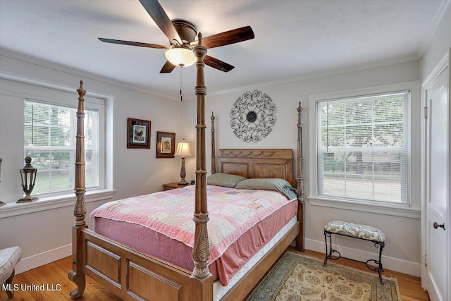 bedroom with ornamental molding, wood-type flooring, and ceiling fan