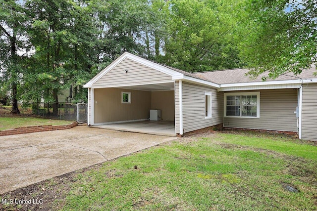 view of side of property with a yard and a carport