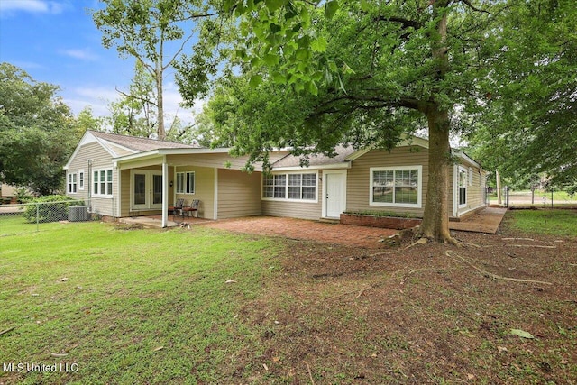 back of house featuring central AC, a yard, and a patio area