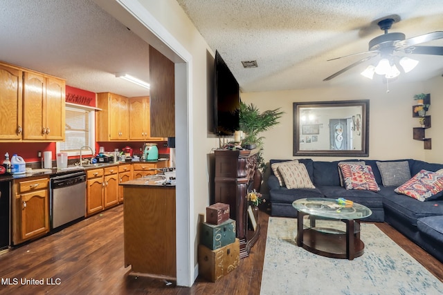 interior space with sink, dark wood-type flooring, ceiling fan, dishwasher, and a textured ceiling