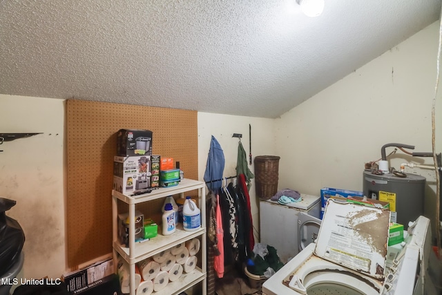 laundry room featuring washer / clothes dryer, water heater, and a textured ceiling