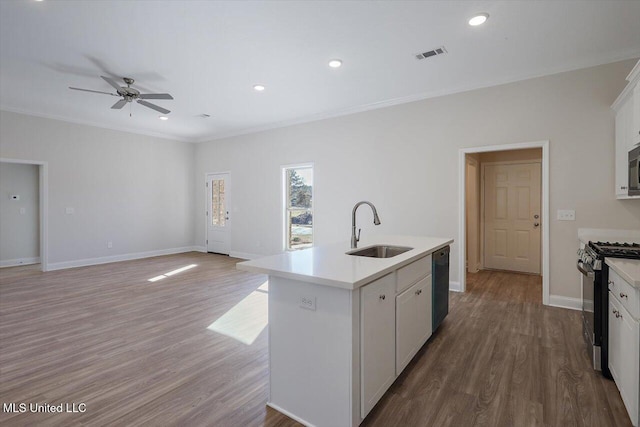 kitchen featuring sink, dishwasher, a kitchen island with sink, white cabinetry, and gas range oven